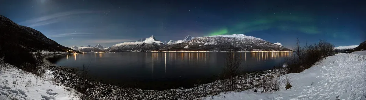 Storfjorden and the Lyngen Alps on a winter night, the mountains behind reindeer sledding near Tromsø