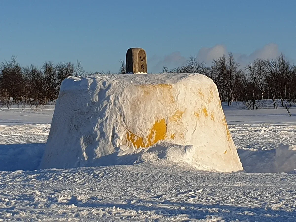 The Three-Country Cairn where Norway, Sweden and Finland meet, the goal of a snowmobile and reindeer sledding tour from Tromsø
